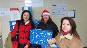 Santa Fund: Diane Begin, Maryjane Martin and Lois Marsh pick up their boxes for delivery. 